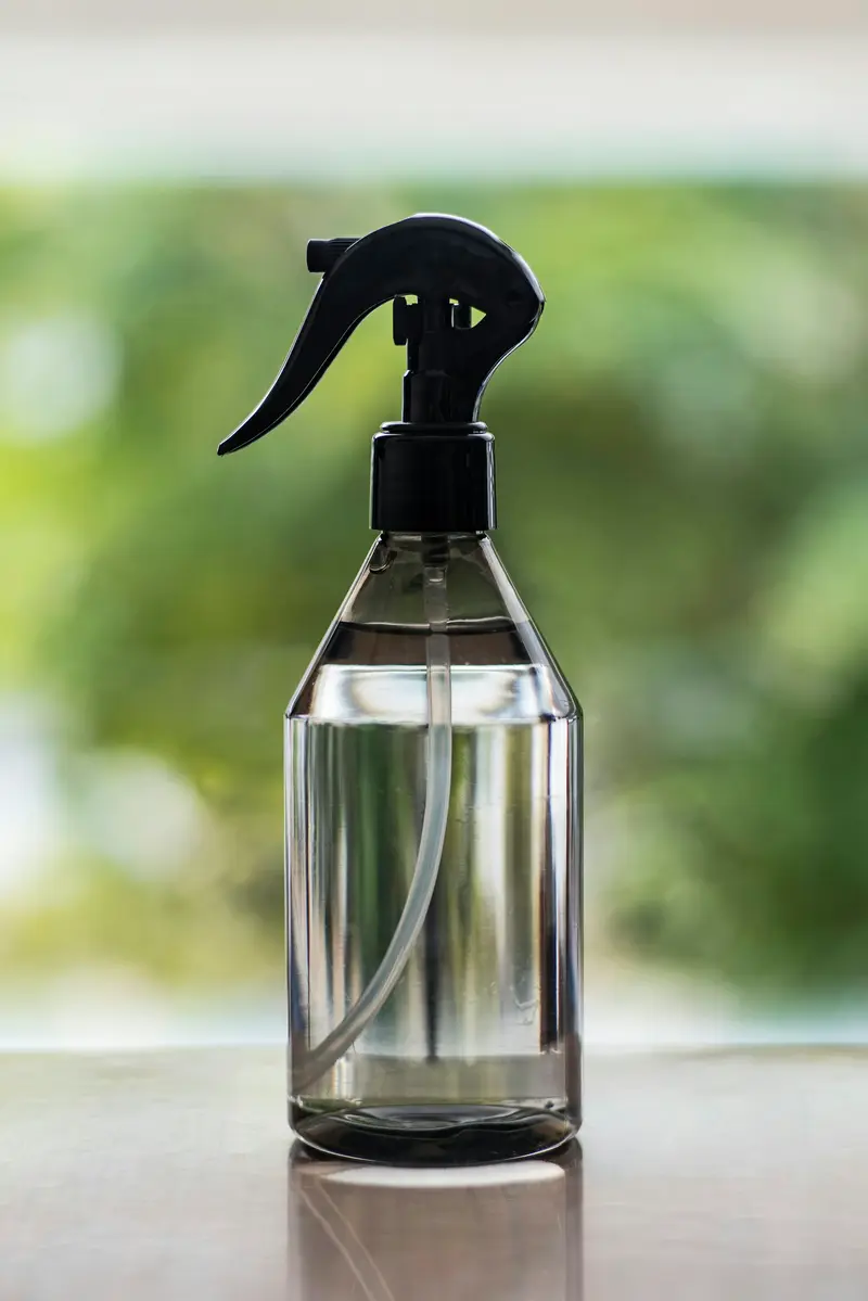 Glass spray bottle on a sunny windowsill D&A Cleaning Ltd