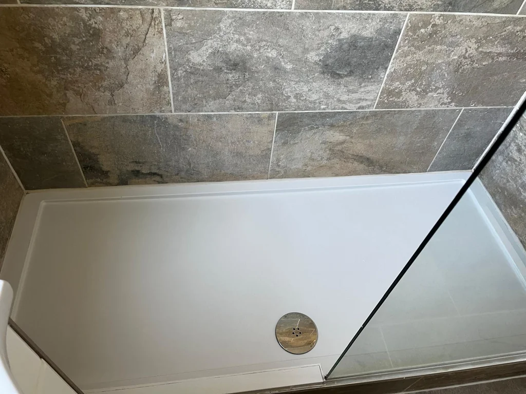 Shower tray restored to bright white after descaling