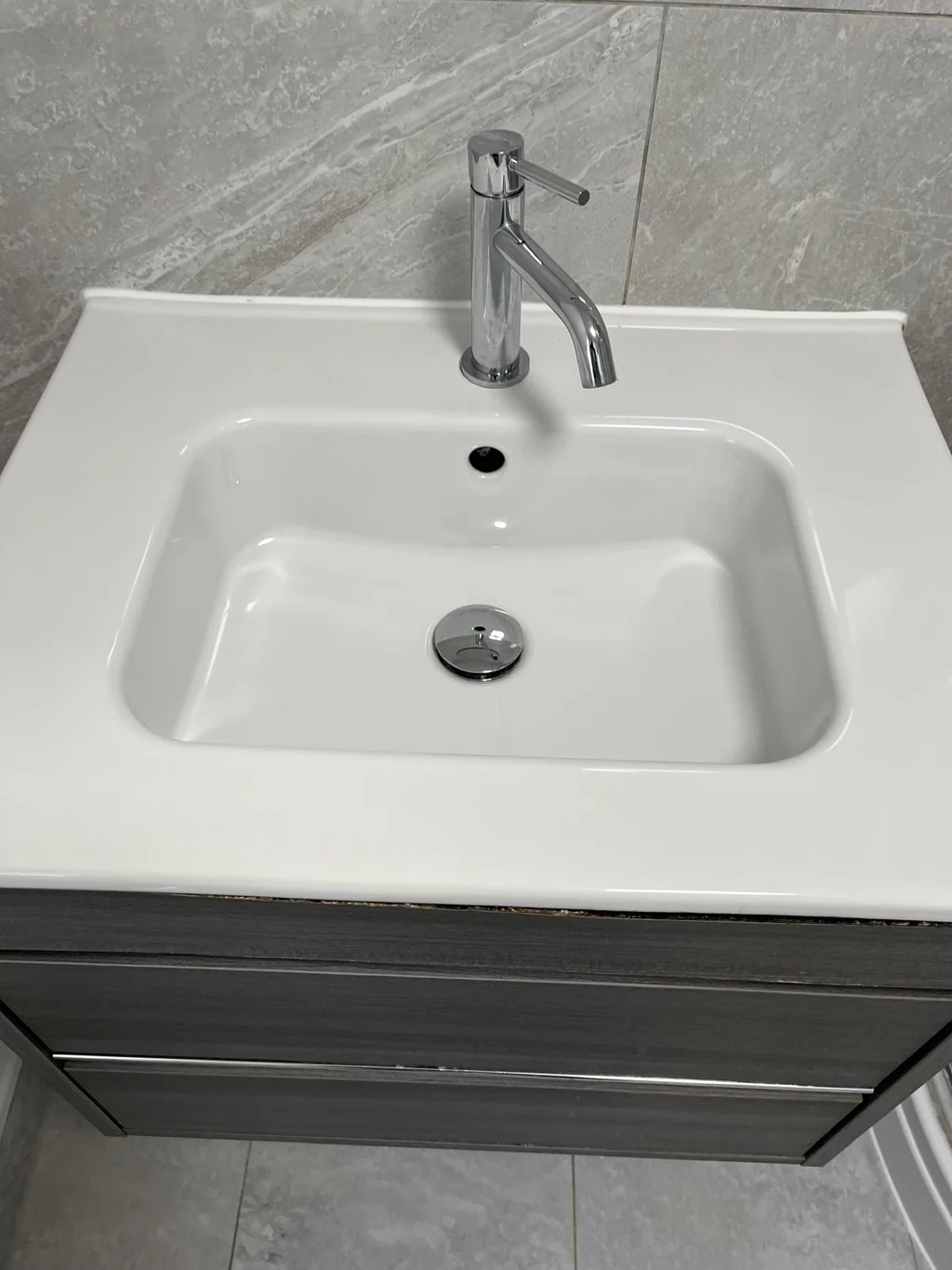 Vanity basin and chrome tap gleaming after clean