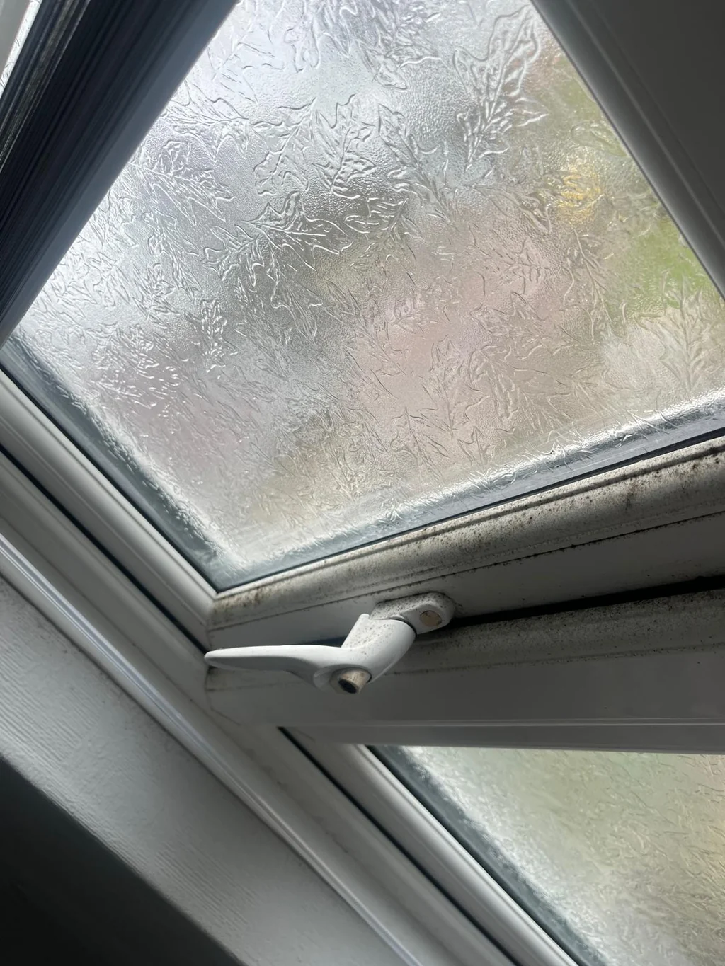 Bathroom window frame with black mould before cleaning